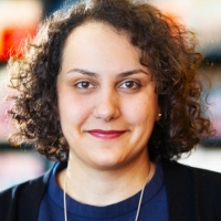 A woman with medium-length, curly brown hair