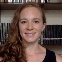 Woman in front of bookshelf