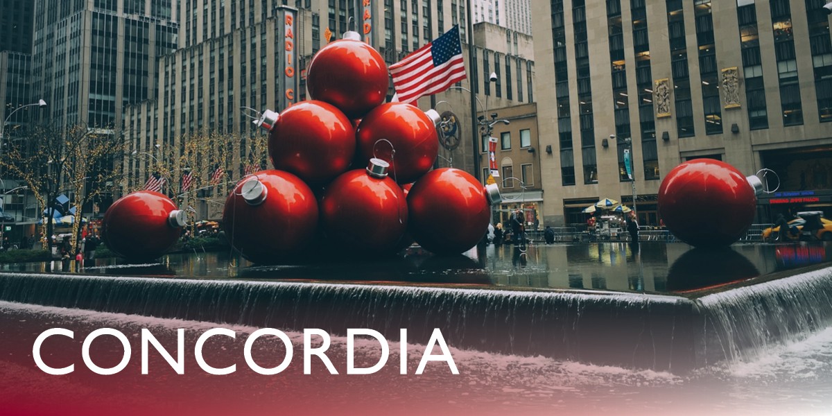 A display of oversized red ornaments over a water fountain in New York City