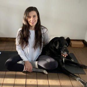 Jade on a yoga mat with a dog