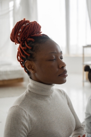 Calm black woman contemplating with closed eyes