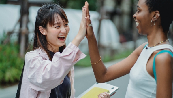 students giving highfive