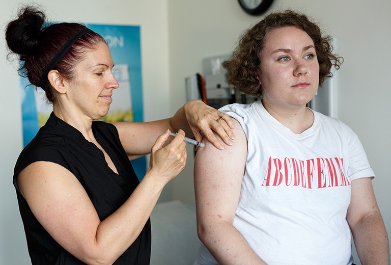 Concordia student is vaccinated by a nurse