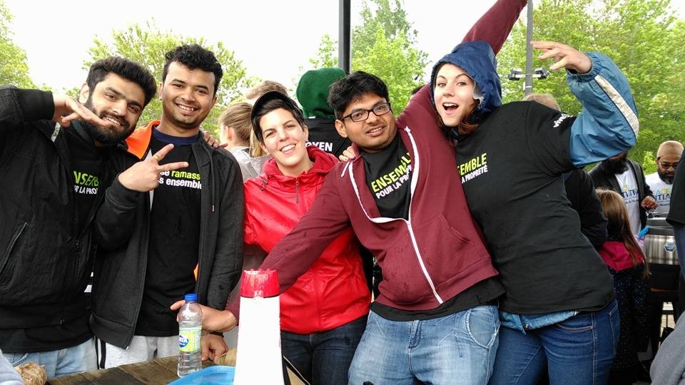 Five students in the park standing and smiling!