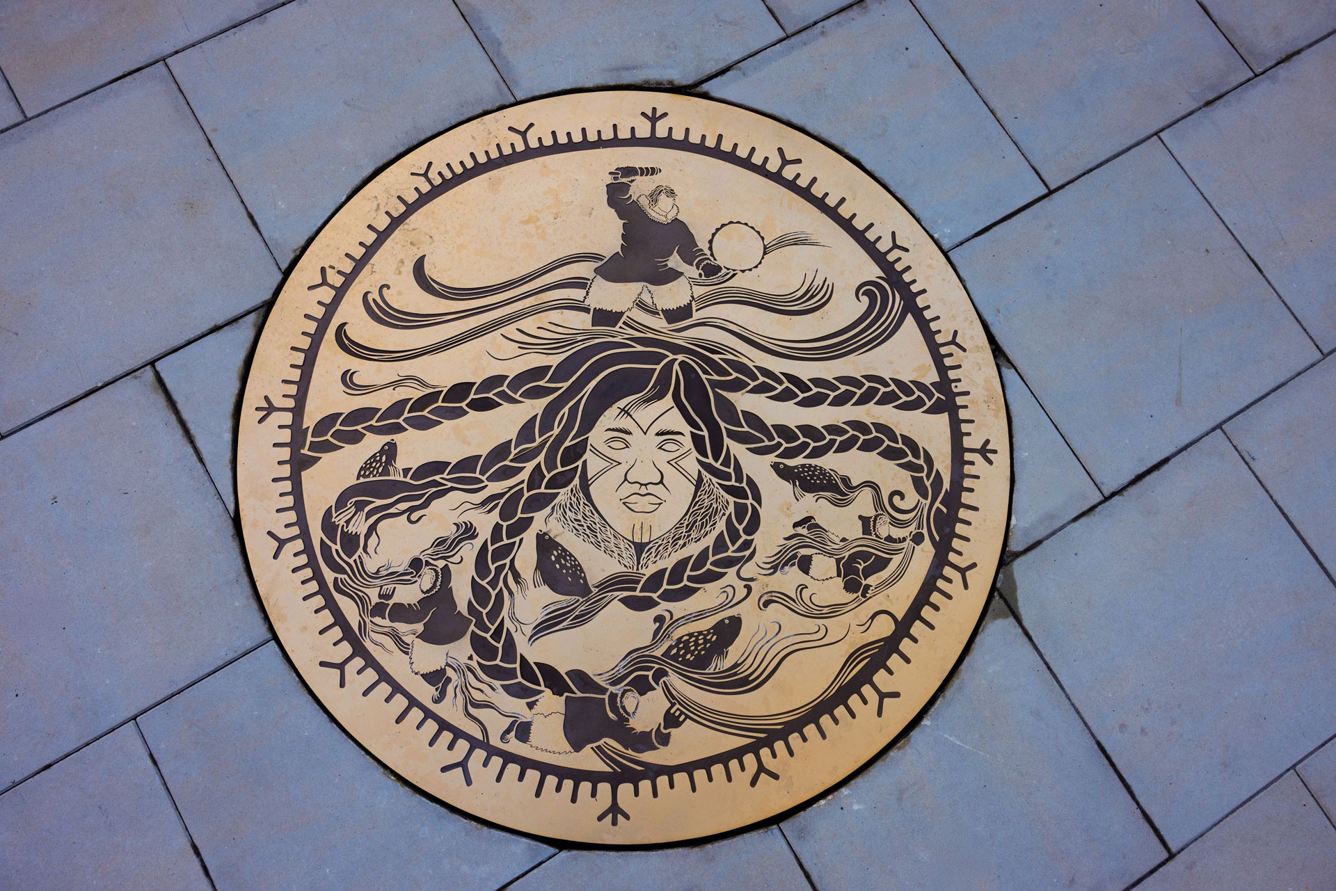 a bronze medallion embedded in paving stones