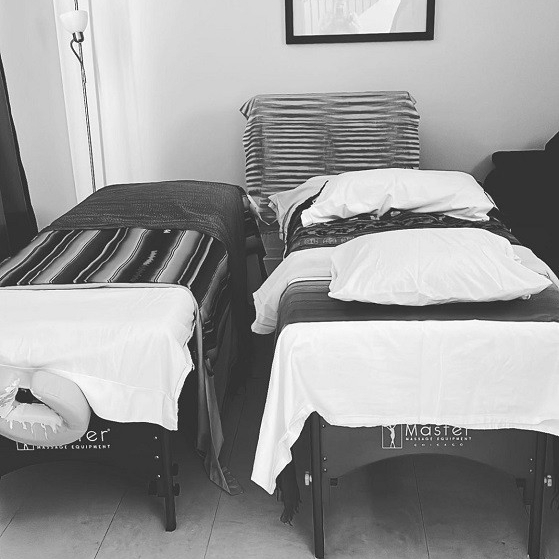 Two massage bed in a black and white frame 