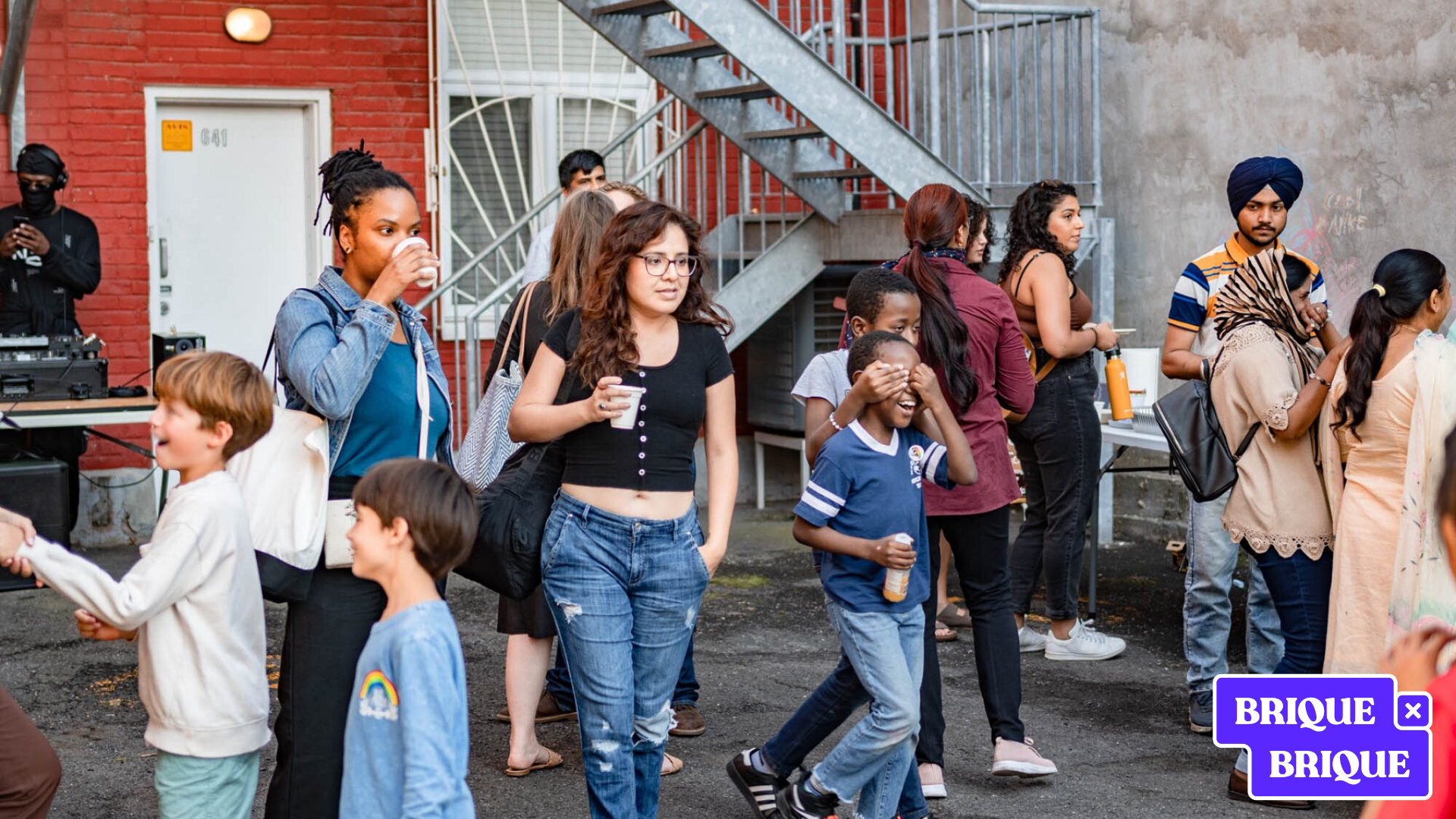 People congragating at a community event with a DJ