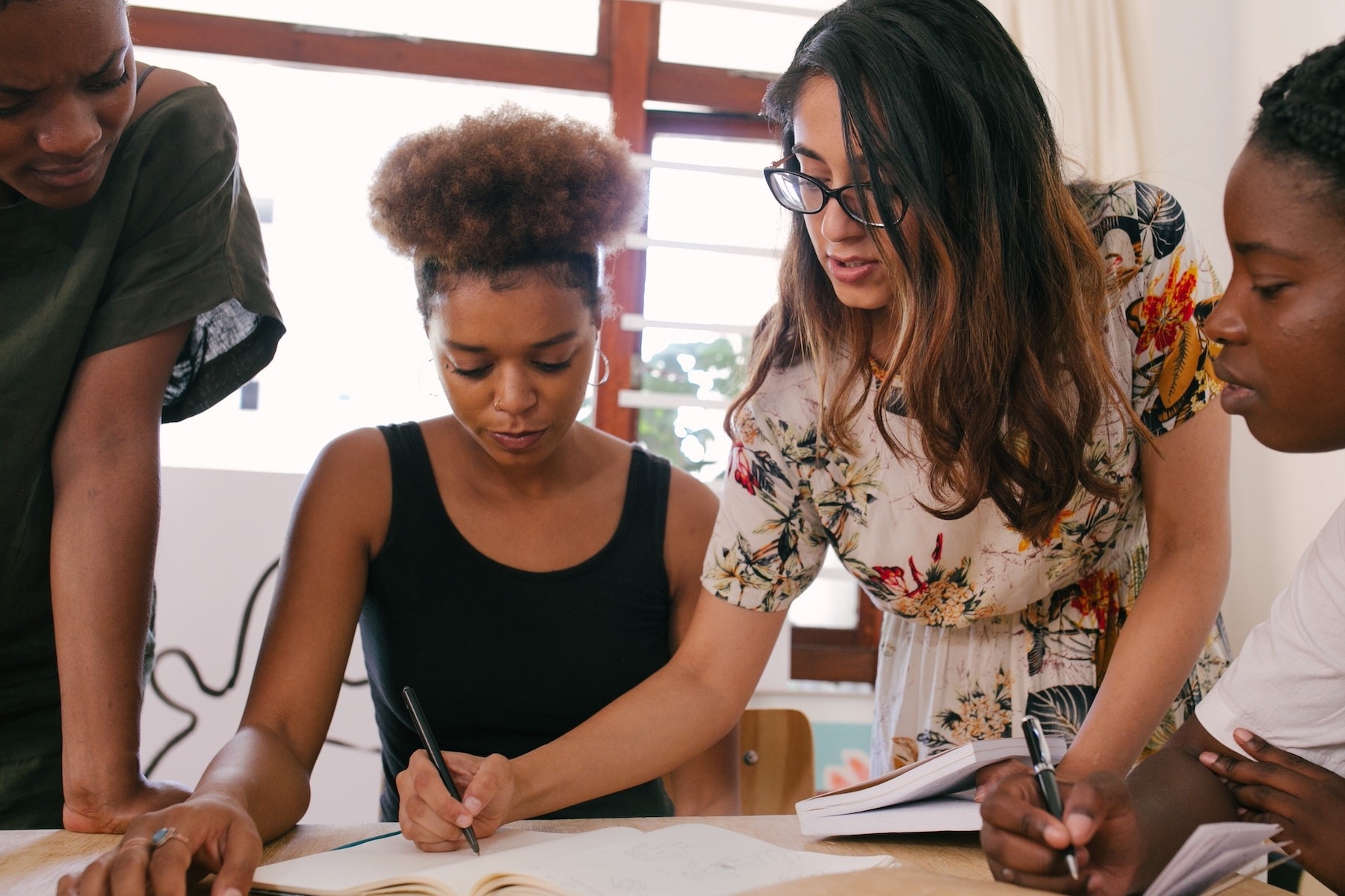 Four young professionals working together