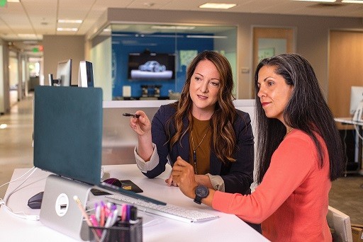 A group of young professionals takes notes