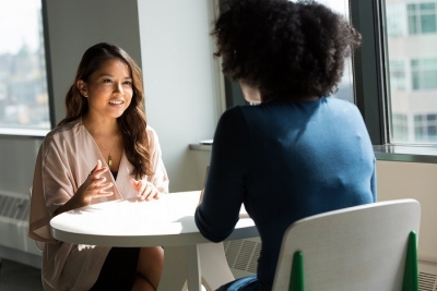 Two women sitting at a table for an interview