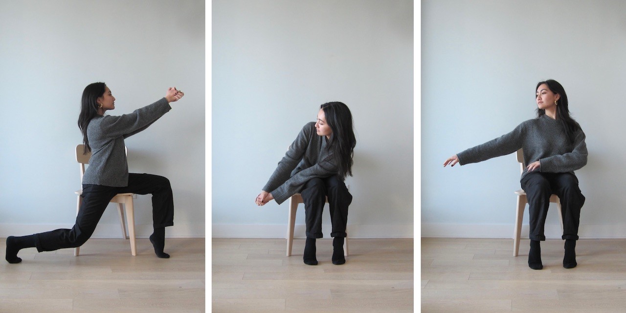 A woman with long dark hair, a grey sweater and black pants and socks sits in a wooden chair. Three photos show her performing a series of seated dance movements. In the first movement her body is turned towards the left and her right leg is extended behind her. She is holding her hands up at eye-level, keeping her arms straight. In the second photo, she is sitting with her knees together. She is holding her hands with her elbows extended and they are reaching towards the right corner of the chair. In the last photo she sits with her left arm resting across her lap and her right arm extended to the side.