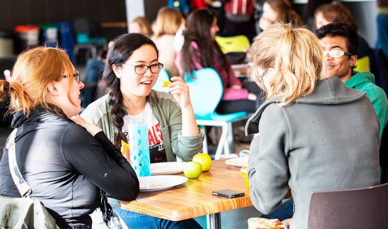 Students eat lunch on the seventh floor of the Hall building