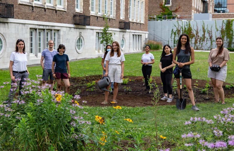 Nine people pose for a picture on Concordia's Loyola Campus after taking part in a planting activity.