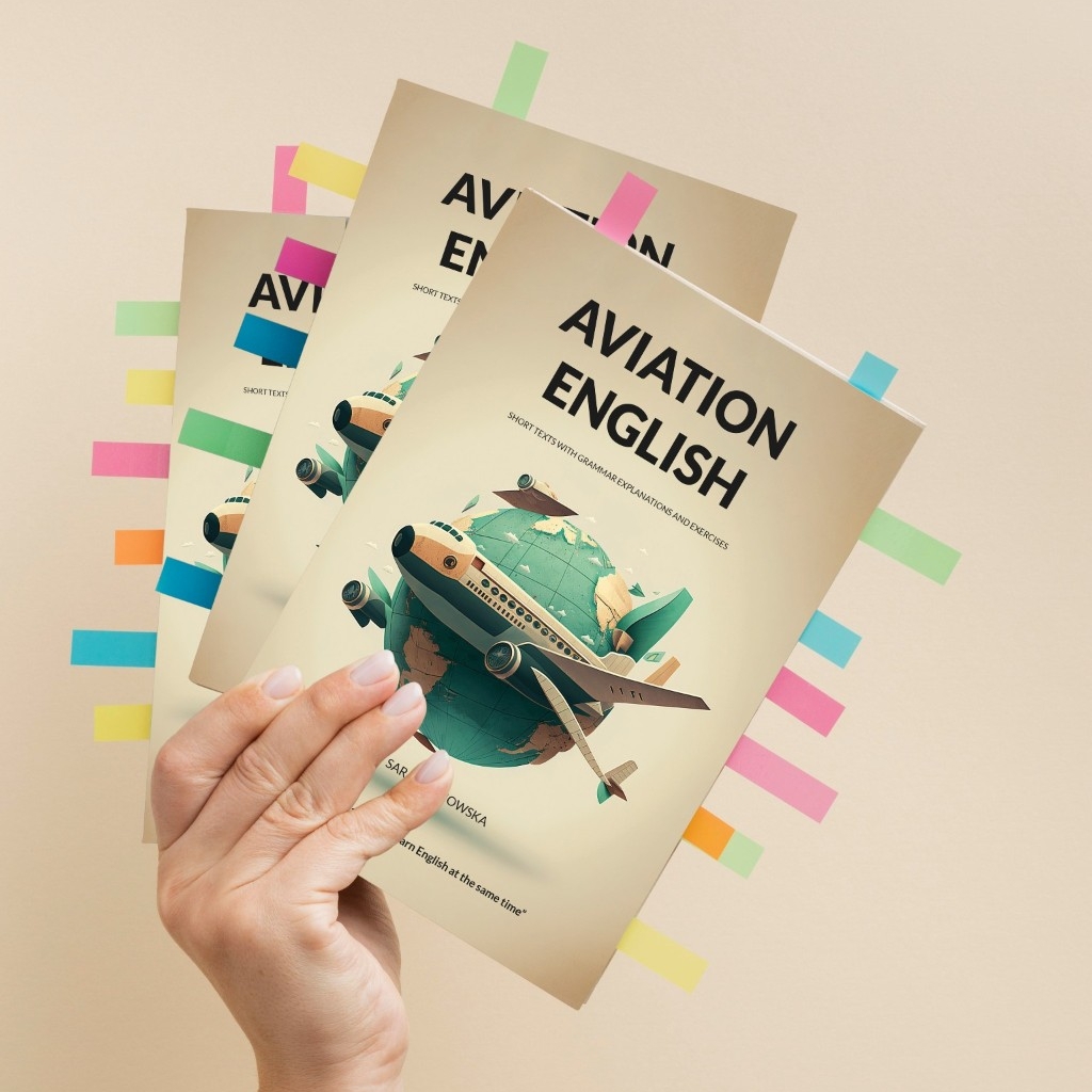 A hand holds up a copy of the book, 'Avation English', with numerous colourful sticky notes poking out of the pages. The cover of the book is an image of an airplane with a globe in the background.