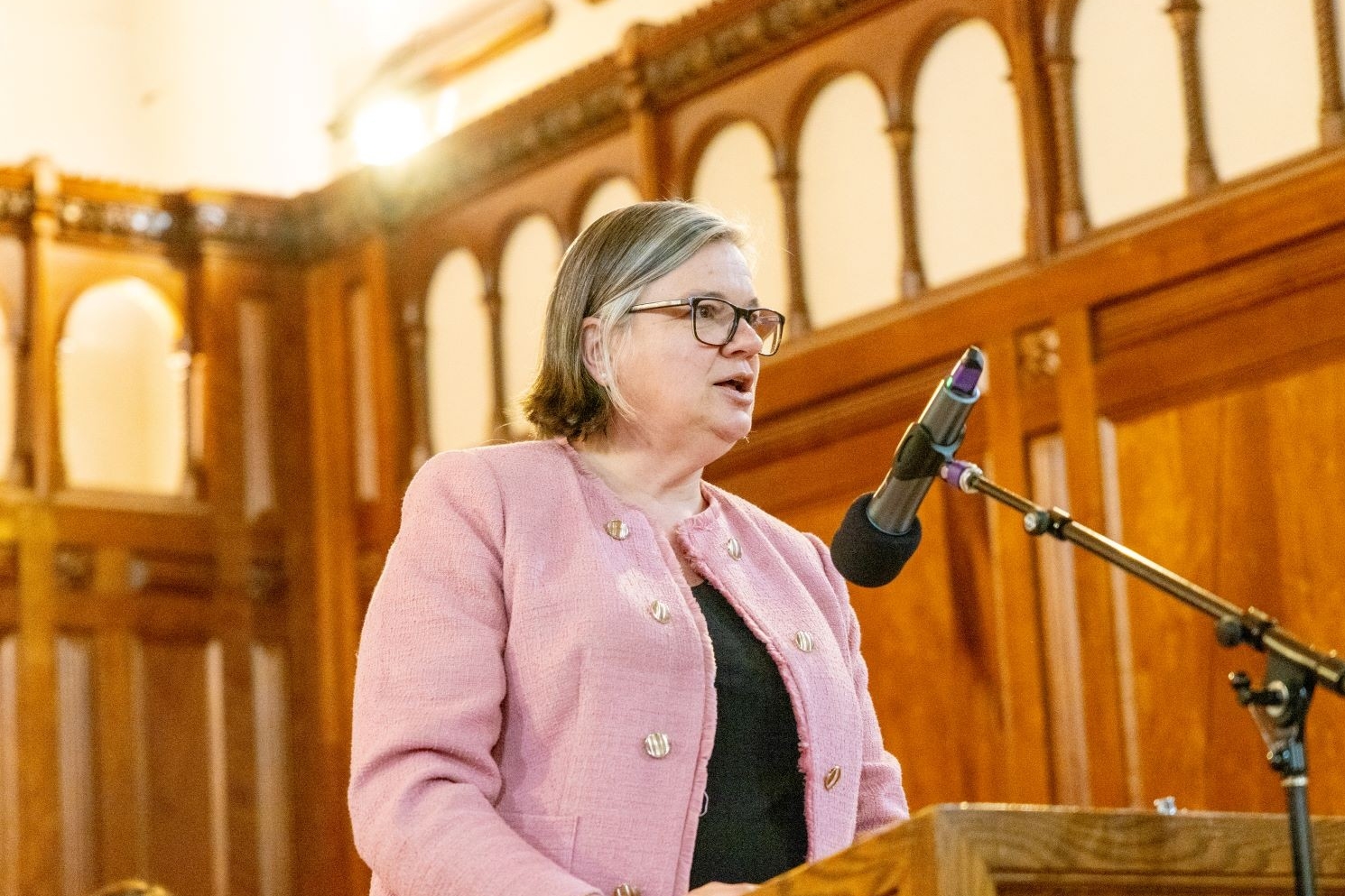 Dean Pascale Sicotte at the podium in the Loyola Chapel