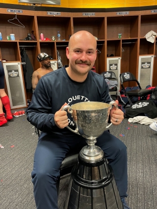 Tristan Castonguay holding the Grey Cup