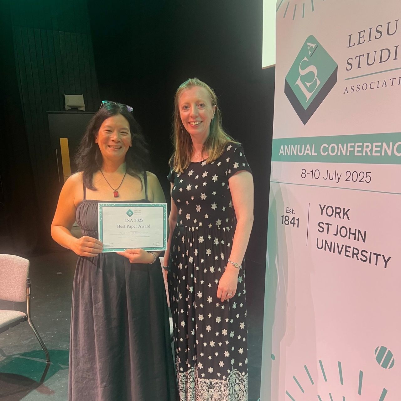 Dr. Felice Yuen and Brittany Butler pose with their award for Best Paper