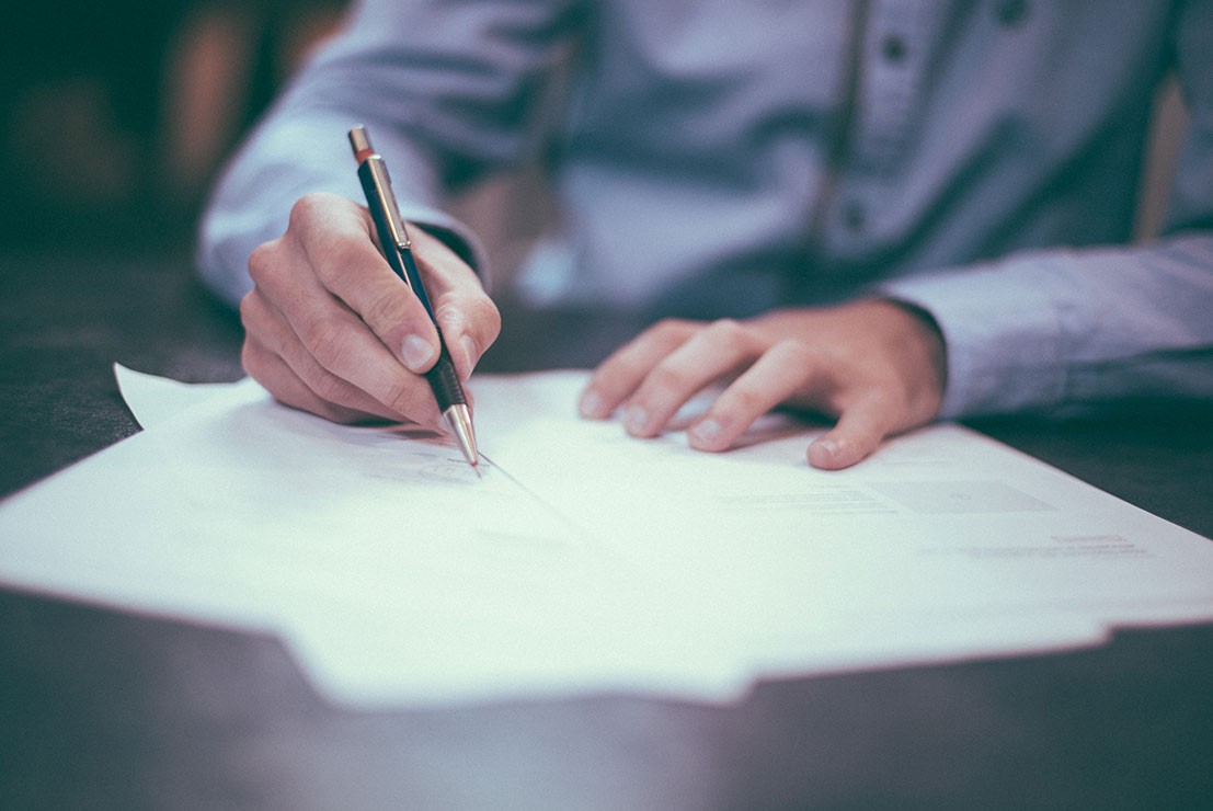 Man signing papers Man signing papers