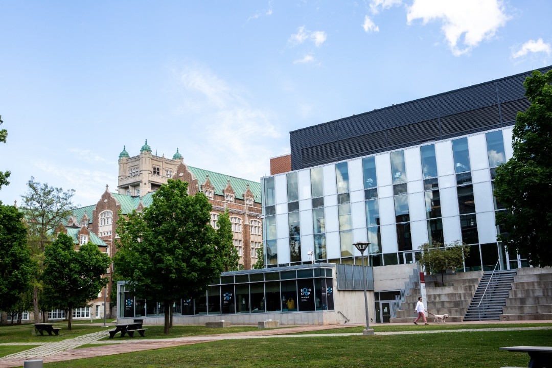 CJ building at the Loyola campus with AD building visible in background. Blue sky with wispy clouds.