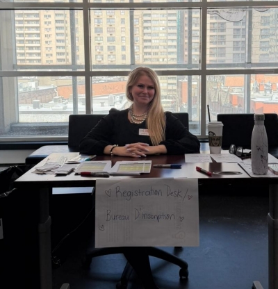 Photo of Maria Stergiou volunteering at the registration desk