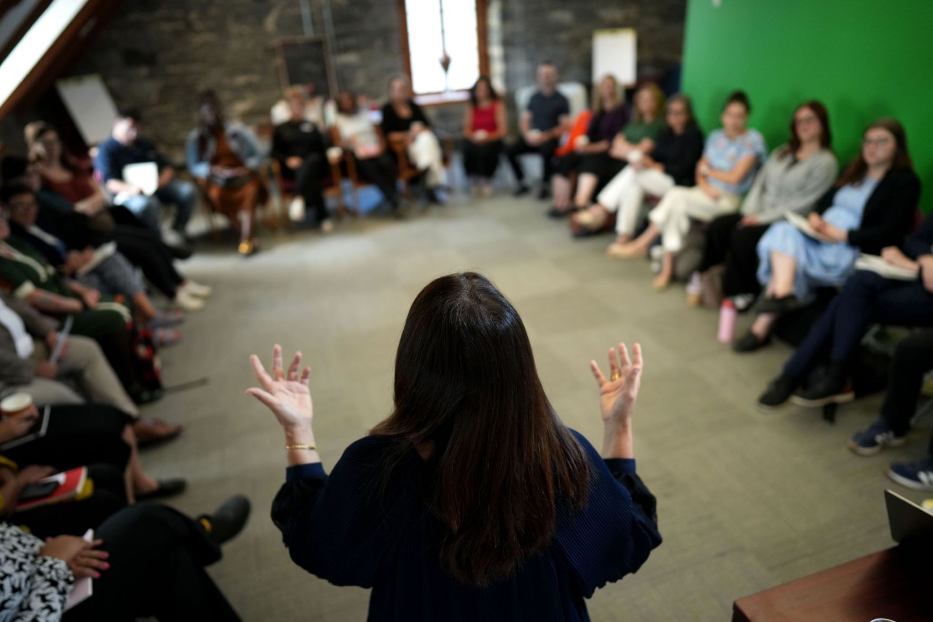 Photo of Zeina Ismail-Allouche (in silhouette) speaking to participants