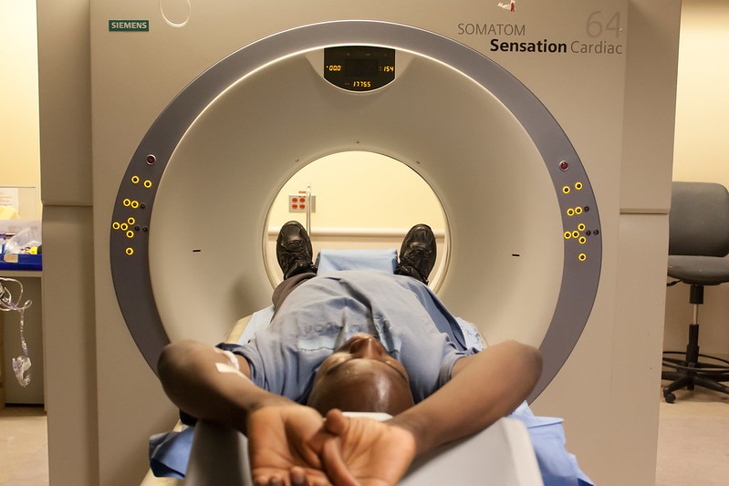 A man lies down before undergoing a CT scan.