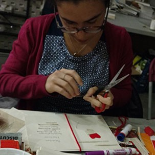 Cutting and pasting at the papier mâché station