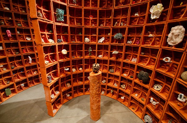 Ceramic sculpture, looking like a curved wall or tablets, orange