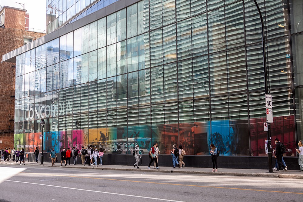 People walking along Guy Street in front of the MB building