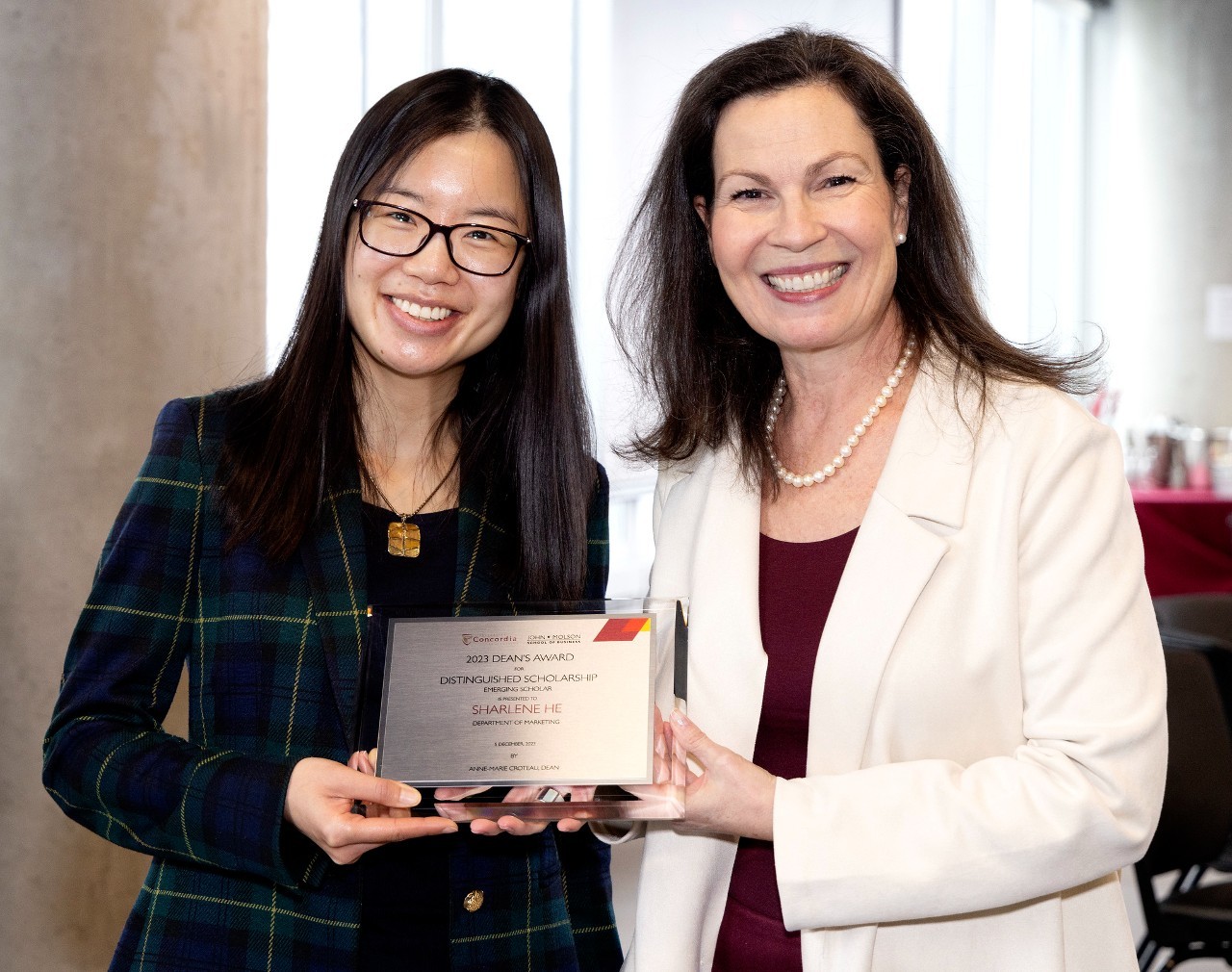 Sharlene He accepts her Dean's Award for Distinguished Scholarship: Emerging Scholar alongside Dean Anne-Marie Croteau