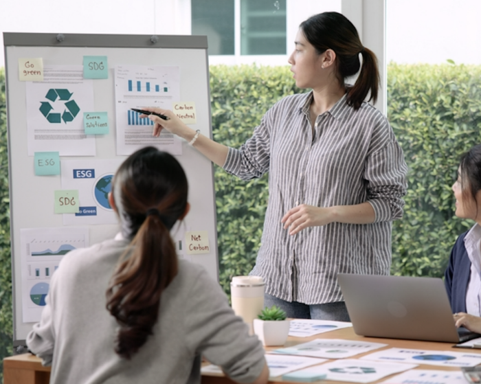A woman shares ESG communications and marketing strategies with her team