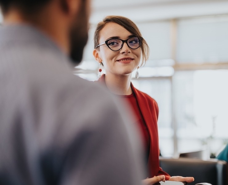 A professional smiles at colleague
