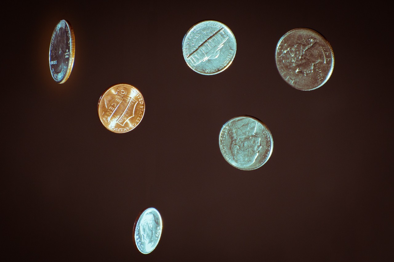 US coins against black background