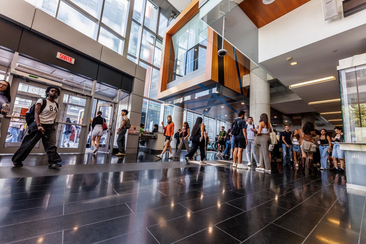 Students walking through the lobby of MB