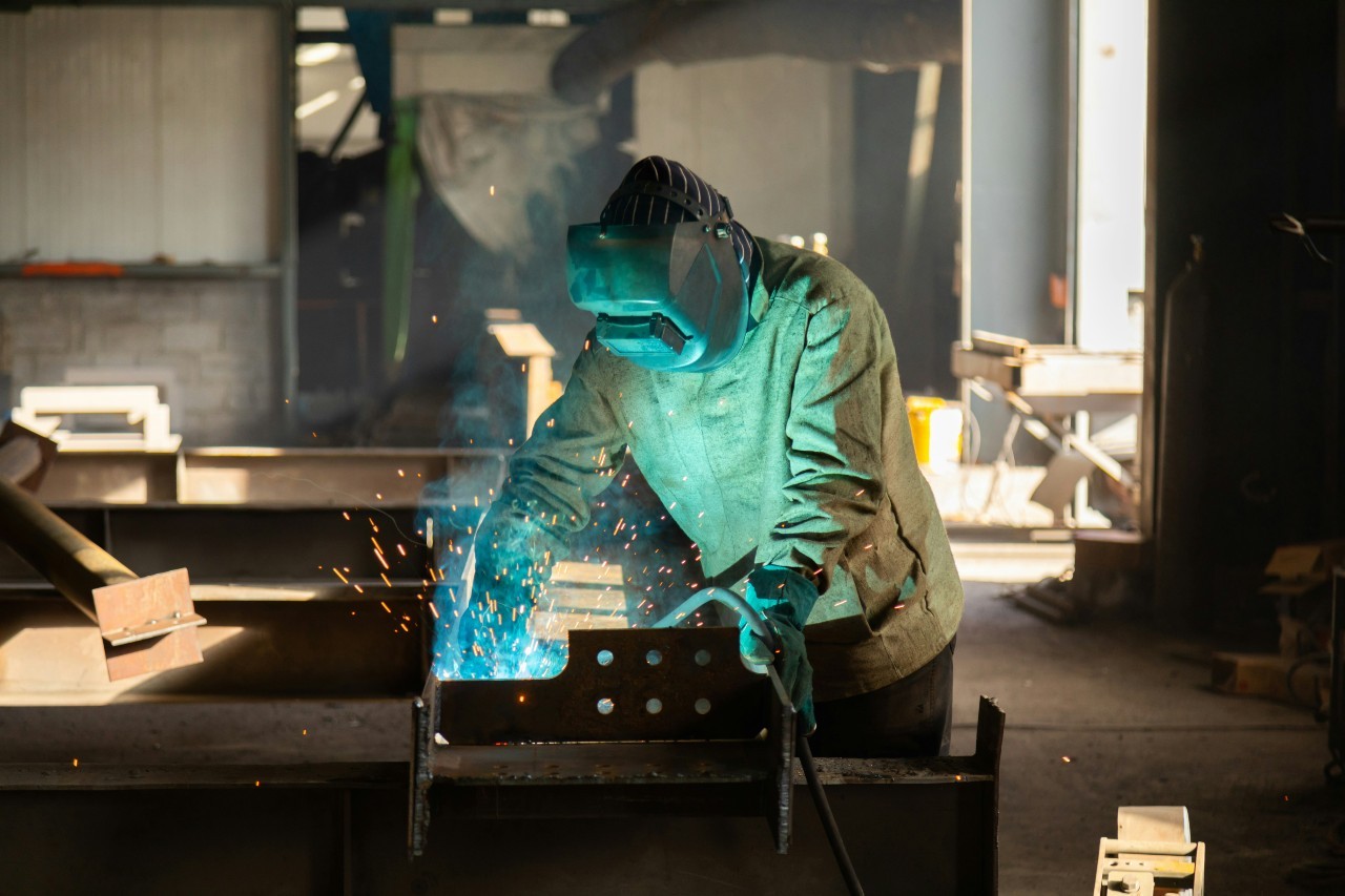 A welder working on a piece of metal.