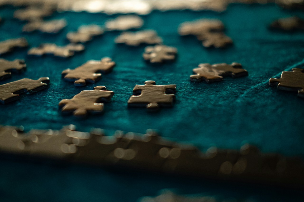 Puzzle pieces spread out on a blue surface