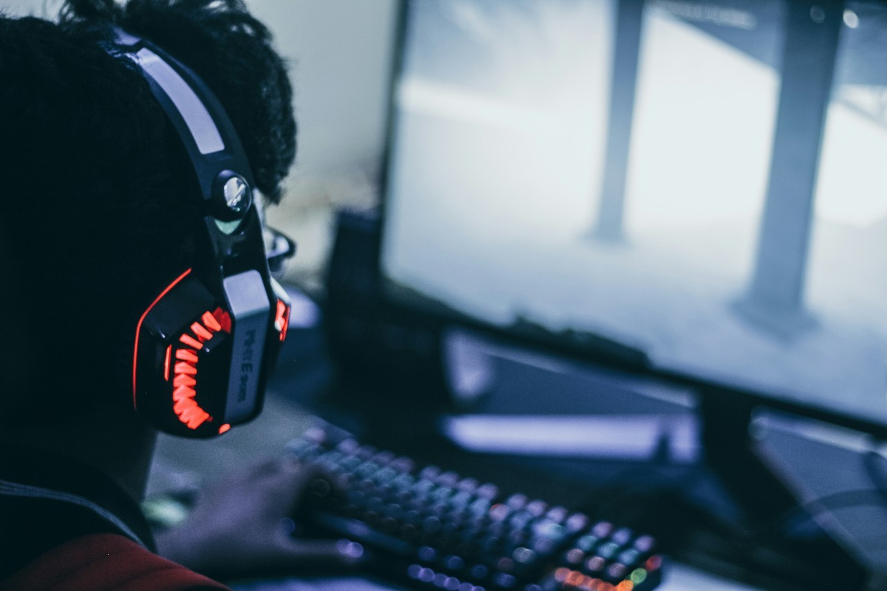 Person wearing headphones looking at computer screen