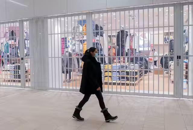 Masked woman walking through mall
