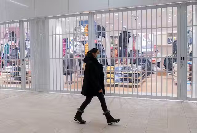 Masked woman walking through mall Masked woman walking through mall