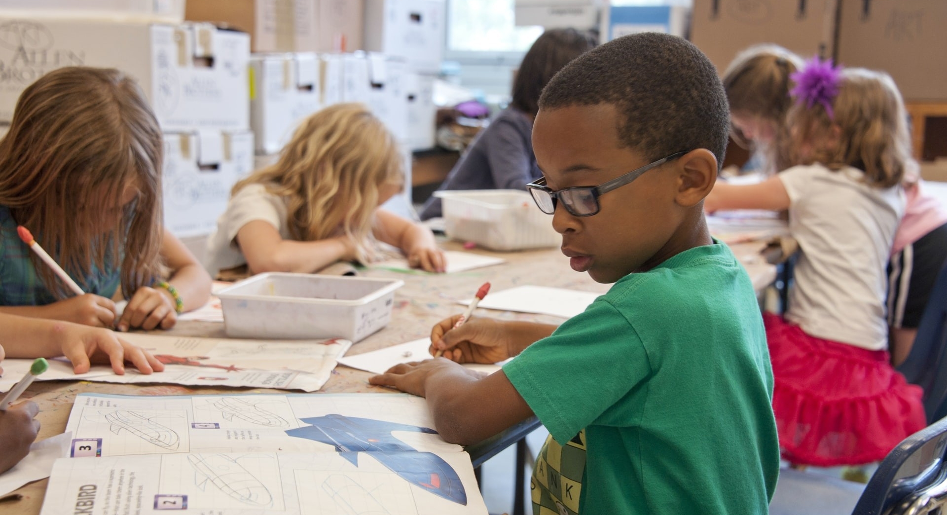 Young children in a classroom doing schoolwork