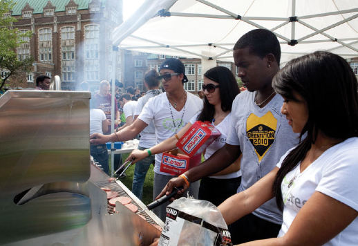 A few students work the grill, Sept. 7 at Loyola. 