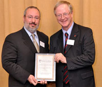 Albert Carbone receives the Award of Distinction from Dean Robin Drew. | Photo by Marc Bourcier