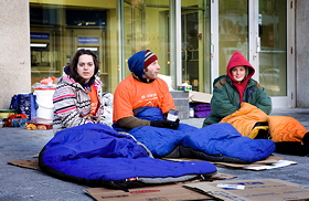 Three hardy students sit on a De Maisonneuve Boulevard sidewalk during last year’s 5 Days for the Homeless campaign, which raised $38,000 for Dans la rue. | Photo by Concordia University