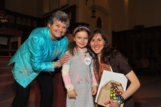 Dean of Students Beth Morey (left) stands with five-year-old Giuliana Stoett (daughter of Political Science professor Peter Stoett) and Julie Norman, Political Science lecturer and 2011 CCSL Award winner, April 7 at Concordia’s Loyola Chapel. | Photo by Howard Kay, PBL photography
