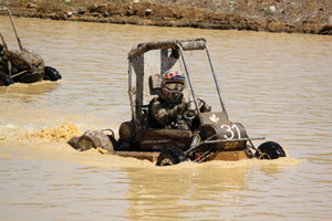 Floating pretty, the off-road vehicle completes the amphibious portion of the track. | Photo by Jody Arsenault