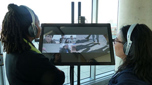 PhD candidate Lisa Ndejuru and symposium co-organizer Monika Kin Gagnon view Planet Galata a web documentary by conference keynote speaker Florian Thalhofer at the opening reception.