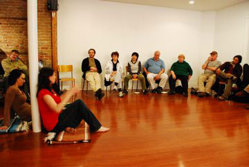Elizabeth Hunt (red shirt) at a University of the Streets Café conversation in 2009. | Photo by Concordia University