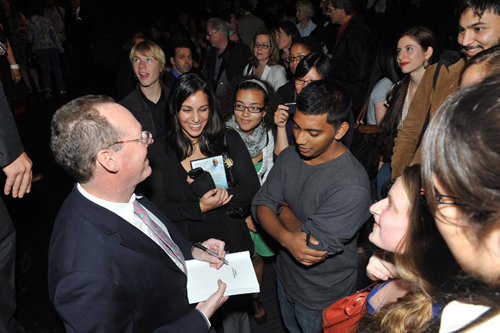 Dr. Paul Farmer, left, signs copies of Mountains Beyond Mountains at the conclusion of Up Close and Personal: A Panel Discussion on Engagement in Haiti, on September 22. | Photo by Ryan Blau/PBL Photography