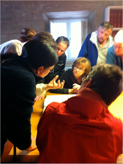 A group of Concordia students and their travel companions view a facsimile of the 12th Codex Calixtinus, a manuscript that contains the guide for pilgrims to the Camino in the archive of the Cathedral of Santiago de Compostela. The original manuscript was stolen from the archive only weeks later and is still missing.