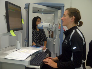 Third-year exercise science student and PERFORM intern Lindsay Hacker (right) conducts tests on one of the centre's plethysmographs. | Photo by Christian Durand 